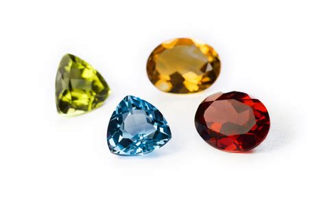 Four Different Colored Diamonds On A White Background