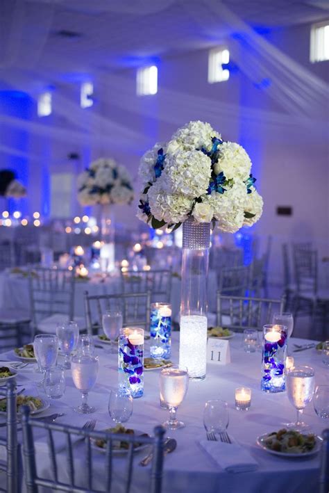 White And Silver Reception Decor With Blue Uplighting Blue Wedding