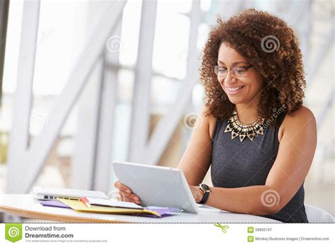 Young African American Woman Working With Tablet In Office