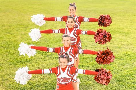 Premium Photo High Angle View Of Cheerleaders Holding Pom Poms While