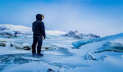 Man Observes The Ice Wasteland Of Iceland In Winter Stock Image Image