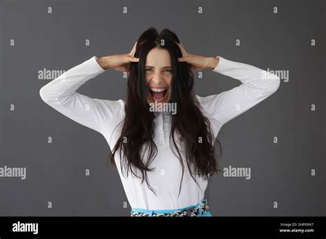 Beautiful Brunette Woman Yells Holding Her Head Stock Photo Alamy