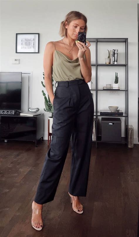 A Woman Is Taking A Selfie In Her Living Room While Holding A Cell Phone