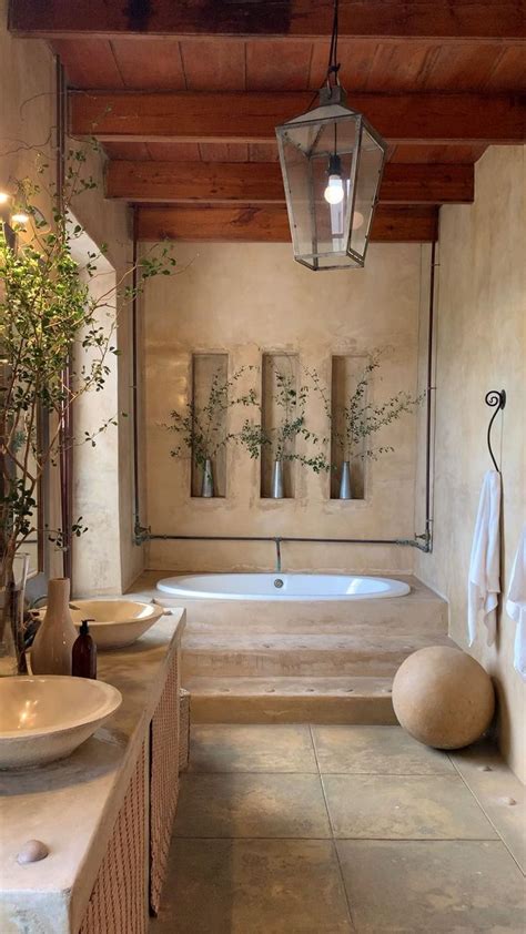 A Bathroom With Two Sinks And A Bathtub Next To A Wall Mounted Planter
