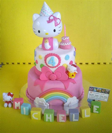 A Hello Kitty Birthday Cake Is Shown With Its Name Spelled Out And Toys