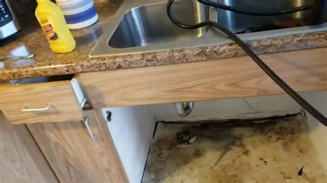 Can you replace flooring without removing cabinets? Replacement of kitchen sink cabinet base. - YouTube
