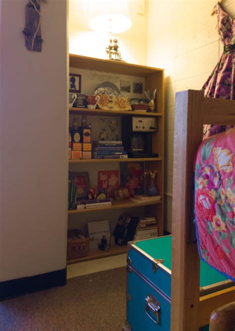 Dorm Room With Styled Bookshelf And Teal Trunk Dorm Room