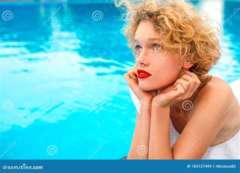 Beautiful Redhead Sitting By The Swimming Pool Stock Image Image Of