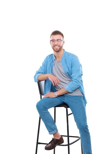 Premium Photo Young Man Sitting On The Chair Isolated Over White