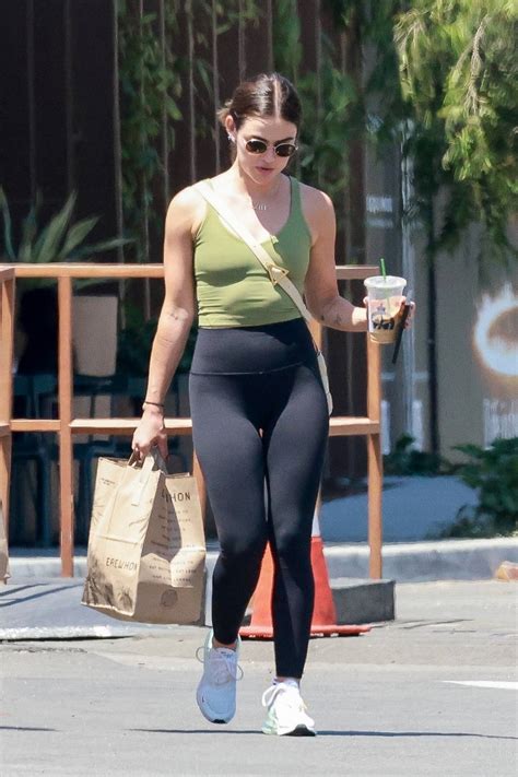 Lucy Hale Keeps It Sporty In A Green Crop Top And Black Leggings While