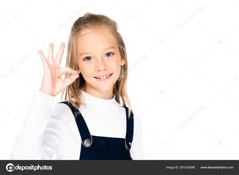 Adorable Smiling Schoolgirl Showing Gesture While Looking Camera