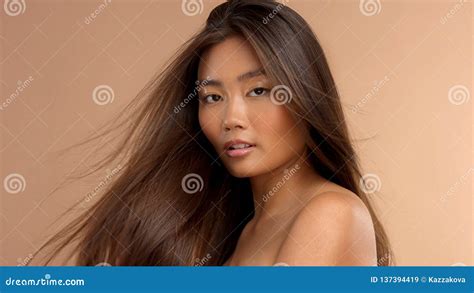 Thai Asian Model With Natural Makeup On Beige Background Stock Image