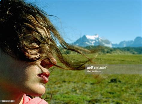 Young Woman With Hair Blowing Across Face Side View Closeup High Res