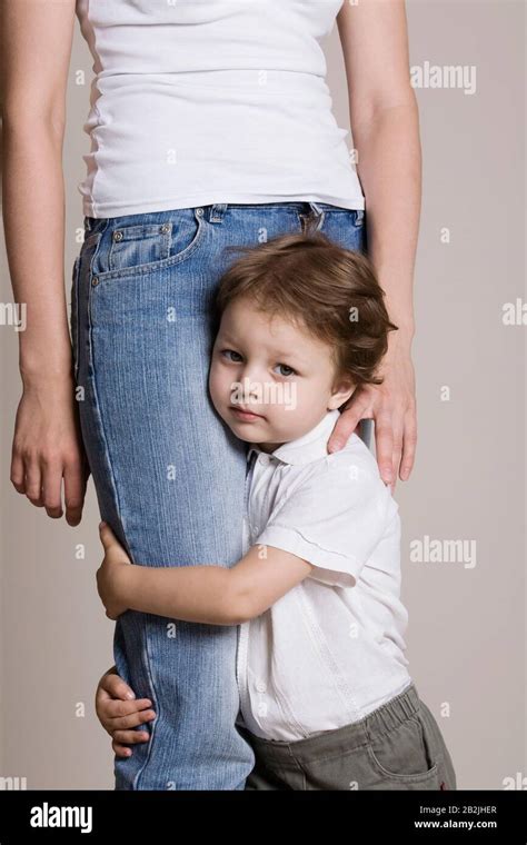 Boy Hugging His Mothers Leg Stock Photo Alamy