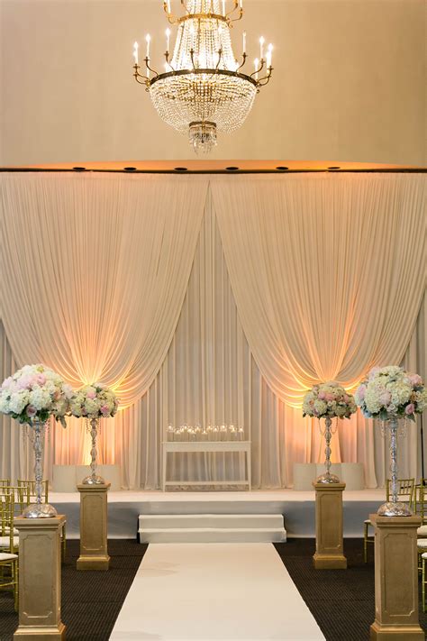 Ceremony At Hotel Ballroom Small Tables Floral Arrangement And Altars