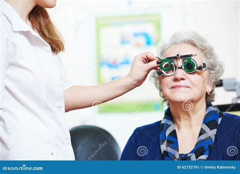 Female Doctor Examines Senior Woman Eye Sight With Phoropter Stock