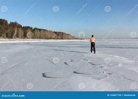 Man In A Cap With A Naked Torso Running Across The Ice Of A Frozen River Stock Photo Image Of