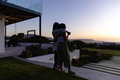 Premium Photo Biracial Lesbian Couple Embracing In Garden At Sunset Lifestyle Relationship