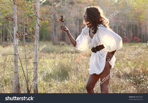Sexy African American Plays With A Butterfly In The Woods Stock Photo