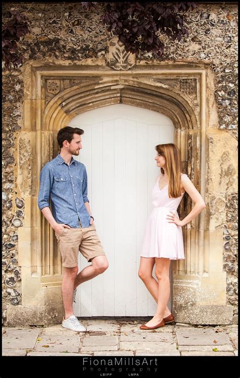 An Engagement Shoot A Couple Lean Against Opposite Sides Of A Archway