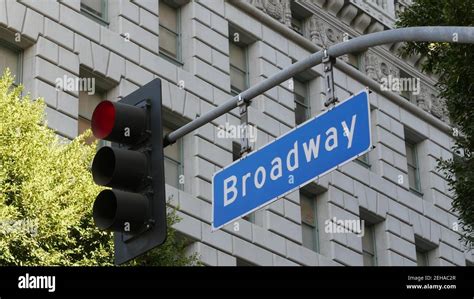 Broadway Street Name Odonym Sign And Traffic Light On Pillar In Usa