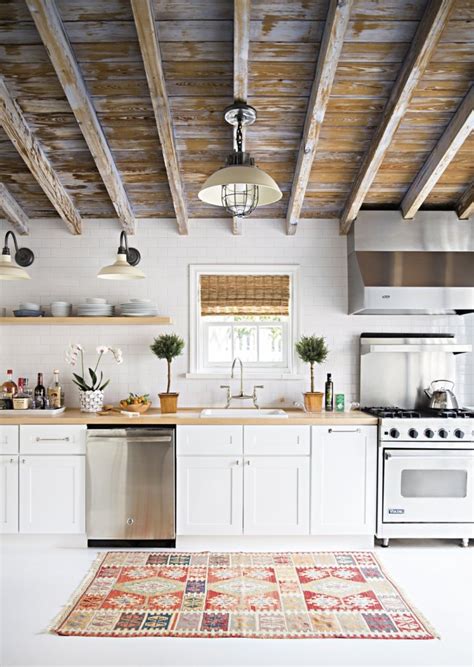 Wood beams add a rustic accent to blue ceilings in a london home designed by rafael de cárdenas. 9 Noteworthy Rustic Wood Ceilings | COCOCOZY