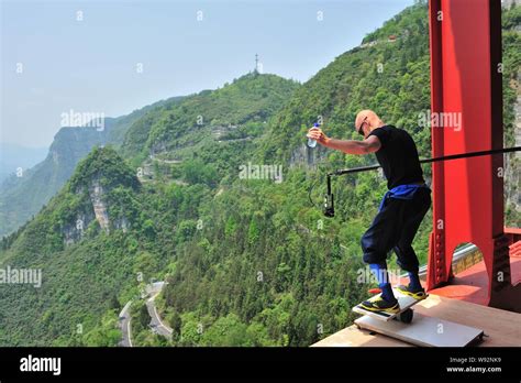 norwegian eskil ronningsbakken performs stunts on the aizhai suspension bridge 330 metres over