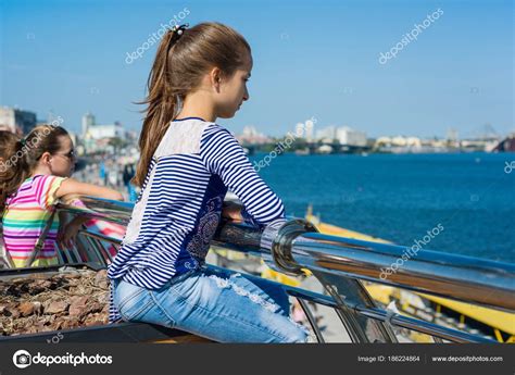 Portrait Of A 10 Year Old Girl In A Profile Background Of A River In A