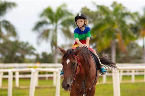 Kids Ride Horse Child On Pony Horseback Riding Stock Image Image Of