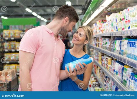 Smiling Couple Buying Milk In Supermarket Stock Image Image Of