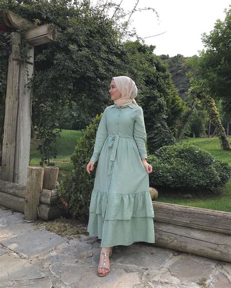 image may contain one or more people people standing tree and outdoor abaya style style maxi