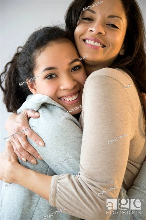 Smiling Mother And Daughter Hugging Stock Photo Picture And Royalty
