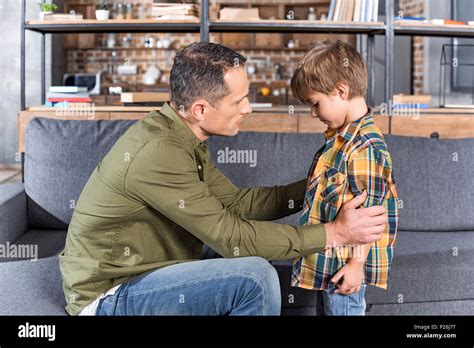 Side View Of Father Talking To Depressed Son At Home Stock Photo Alamy