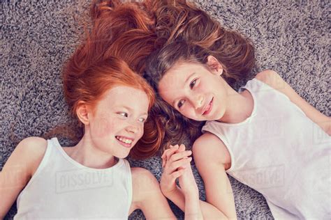 Best Friends Holding Hands On Carpet Stock Photo Dissolve