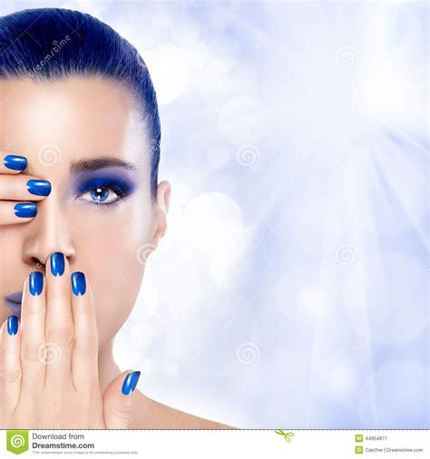 beautiful girl in blue with hands on her face nail art and make stock image image 44954871