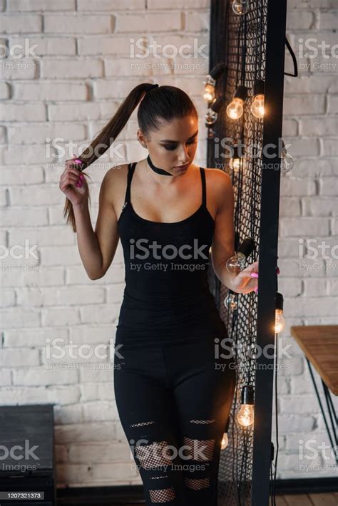 Portrait Of Amazing Stylish Young Woman Posing At Loft Style Room