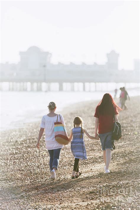 Lesbian Couple And Daughter Holding Hands On Beach Photograph By Caia