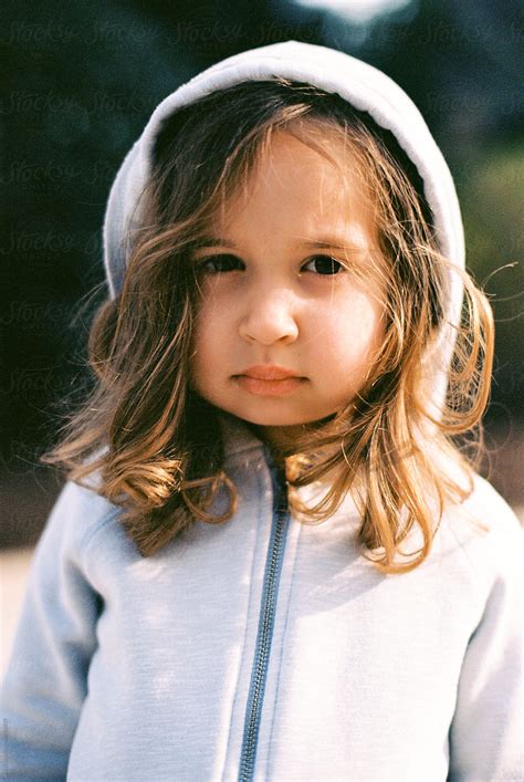 Portrait Of A Cute Young Girl With Big Cheeks Wearing A Hoodie By