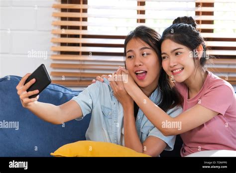 Happy Asian Lesbian Selfie With Mobile Phone At Sofa In Houselgbtq Lifestyle Concept Stock