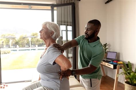 Premium Photo African American Male Physiotherapist Giving Back Massage Therapy To Caucasian