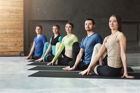 Young Women And Men In Yoga Class Back Stretching Stock Photo Image