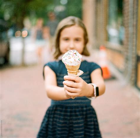 Beautiful Young Girl Holding An Ice Cream Del Colaborador De Stocksy