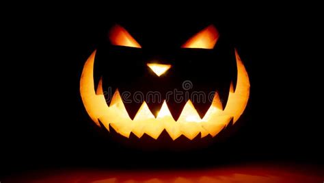 Scary Face Halloween Pumpkin On A Black Background Luminous Smiling