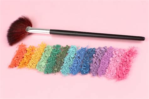 Premium Photo Rainbow Crushed Eyeshadow And Professional Makeup Brush On Pink Background
