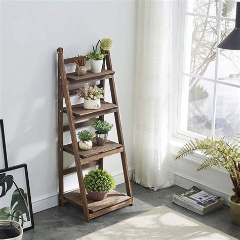 A Wooden Shelf With Potted Plants On It Next To A Window In A White Room
