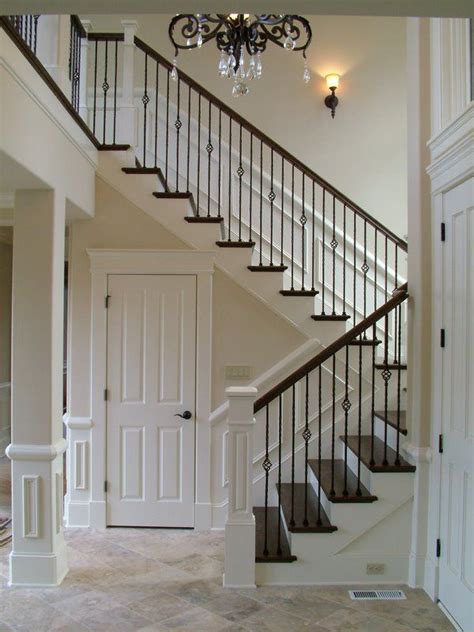 Balusters, also known as spindles, are an important part of a railing system. Wood Staircases With Iron Balusters | House stairs, Stair ...