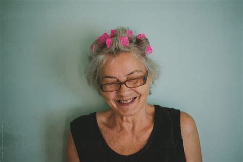 Grandma With Hair Rollers Sincerely Laughing By Stocksy Contributor