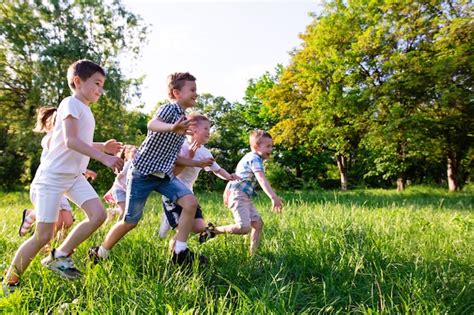 Premium Photo Children Play Outdoors Running And Having Fun On A