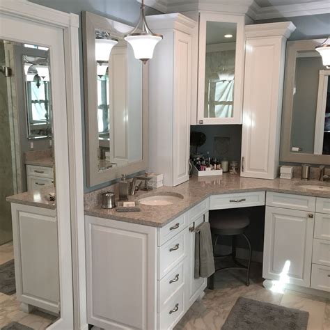 A Bathroom With Two Sinks And Mirrors On The Wall Along With Other