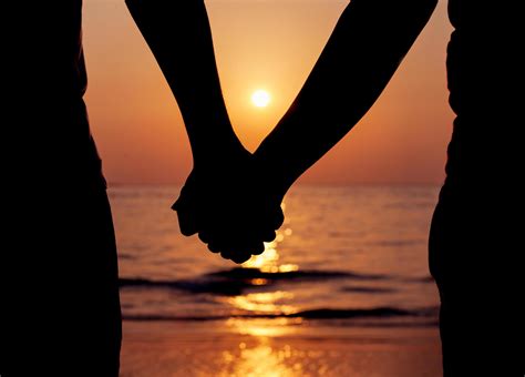 Silhouette Of A Couple Holding Hands At Sunset 2004206 Stock Photo At
